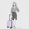 A woman stands next to a suitcase. Produktbild-Vorschau