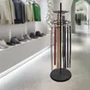 A rotating display stand for belts and ties in a retail store setting. Podgląd zdjęcia produktu