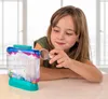 A young girl is looking at an Aqua Dragons habitat with a magnifying glass. Voir les images du produit