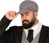 A man wearing a suit and a cap, tipping his hat. Produktbild-Vorschau