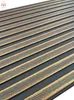 A close-up, angled view of a wall panel with a ribbed texture and a metallic gold inlay. Náhled obrázku produktu