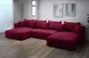 A large, dark red sectional sofa with multiple cushions is shown in a well-lit room with light gray walls and wooden flooring. Náhľad obrázku produktu