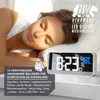 A woman sleeping peacefully next to a digital alarm clock displaying the time and temperature. Náhled obrázku produktu