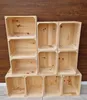 A stack of empty wooden crates against a wooden background. Náhled obrázku produktu