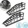 Two black metal car ramps are shown, with a close-up inset of a car tire on one ramp. Textual information about load capacity and height is present in circular badges. Podgląd zdjęcia produktu