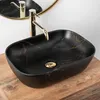 A black marble-effect basin with gold accents, placed on a wooden countertop. Produktbild-Vorschau