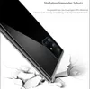 A black phone case is shown on a cracked white surface, suggesting shock absorption. Produktbild-Vorschau