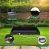 A black outdoor shower tray is set up on a green lawn in a garden, with a hose attached. Produktbild-Vorschau