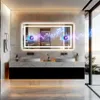A modern bathroom with a large illuminated mirror above a double vanity with two sinks. The mirror displays animated musical notes and sound waves, suggesting it has a Bluetooth speaker feature. Podgląd zdjęcia produktu
