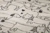 A close-up view of a blanket with a pattern of hand-drawn dogs. Produktbild-Vorschau