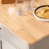 A close-up view of a wooden countertop with two glasses and a bowl of chips. Voir les images du produit
