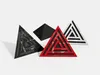 Four triangular acoustic foam panels with different designs and colors are arranged on a white background. Podgląd zdjęcia produktu