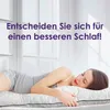 A woman is sleeping peacefully on a bed, using a large pillow. Produktbild-Vorschau