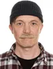 A man wearing a beanie and a plaid shirt, with a fake mustache. Produktbild-Vorschau