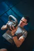 A man is performing a workout with a kettlebell. Náhľad obrázku produktu