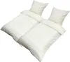 Two sets of bedding, each with a duvet cover and a pillowcase, are arranged diagonally on a white background. Produktbild-Vorschau