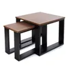 Two nesting coffee tables with brown wooden tops and black metal frames, displayed against a white background. Náhled obrázku produktu