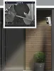 A security camera is mounted on a wooden wall next to a door, with a screen capture showing a burglar. Náhľad obrázku produktu