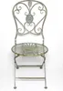 A vintage-style metal chair with ornate detailing. Náhled obrázku produktu