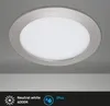 A close-up, slightly angled view of a silver LED ceiling light fixture against a light gray background. Produktbild-Vorschau