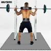 A man is performing a squat with a barbell in a gym setting, standing on protective mats. Produktbild-Vorschau