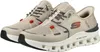 A pair of beige athletic shoes with gray laces and orange accents. Voir les images du produit