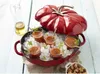 A red Staub tomato-shaped cocotte filled with ice and shot glasses of gazpacho, with a bottle of olive oil and a small bowl of croutons nearby. Náhľad obrázku produktu