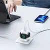 A person's hand is visible near a laptop, while a phone and an Apple Watch are charging on a white desk. Podgląd zdjęcia produktu
