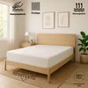 A white fitted sheet is shown on a wooden bed frame in a bedroom setting. Produktbild-Vorschau