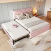A pink upholstered bed with a pull-out trundle bed in a bedroom setting. Anteprima dell’immagine prodotto