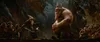 A scene from a fantasy movie set in a cave, featuring a wizard and a large creature. Podgląd zdjęcia produktu