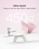 A pink keyboard case and a coffee cup are balanced on a white seesaw, with large text indicating weight comparison. Produktbild-Vorschau