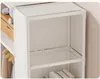 A close-up view of a modular, foldable wardrobe with white panels and clear plastic connectors. Some items like a wooden box with stuffed toys and clothes on hangers are visible on the shelves. Podgląd zdjęcia produktu
