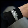 A close-up shot of a person's wrist wearing a silver Casio watch with a black shirt sleeve. Náhľad obrázku produktu