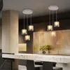 A modern kitchen or bar area with pendant lights hanging over a marble countertop. Produktbild-Vorschau