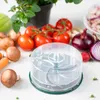 A clear shot of a food chopper with various fresh vegetables and mushrooms arranged around it on a white surface. Anteprima dell’immagine prodotto