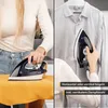 A split image showing a person ironing clothes horizontally on a yellow towel and vertically on a shirt. Produktbild-Vorschau