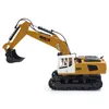 A yellow and white toy excavator with black tracks is shown against a white background. Náhľad obrázku produktu
