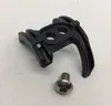 A black plastic cable guide and a silver screw on a white background. Produktbild-Vorschau