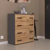 A modern chest of drawers with a wood-effect front and gray frame, placed in a hallway next to a door. Produktbild-Vorschau