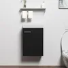 A black vanity cabinet with a white countertop is mounted on a white wall above a wooden floor. Two folded white towels hang from a silver rack above the cabinet. A toilet is partially visible to the right. Anteprima dell’immagine prodotto