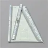 Three rolls of transparent self-adhesive book protection film are laid out on a grid background. Podgląd zdjęcia produktu