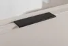 A close-up view of a black handle on a beige cabinet. Produktbild-Vorschau