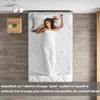 A woman sleeping on a mattress, with a bedside table and lighting fixtures visible. Voir les images du produit