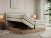 A bedroom scene featuring a king-size boxspring bed with storage, a bedside table with a lamp, and a plant. Produktbild-Vorschau