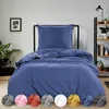 A bed with blue bedding is displayed in a room setting. Several swatches of different colored bedding are shown at the bottom of the image. Produktbild-Vorschau