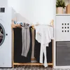 A laundry room scene with a washing machine and a two-compartment laundry basket filled with clothes. Náhled obrázku produktu