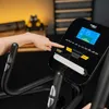 A person's hand is touching the console of a TREX SPORT Crosstrainer. Produktbild-Vorschau