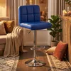 A blue bar stool is shown in a living room setting, next to a sofa and a wooden counter. Produktbild-Vorschau