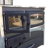 Close-up of a wood-burning stove with its doors open, showing the interior and a thermometer. Produktbild-Vorschau